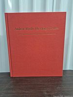 Front cover of red cloth hardcover with gilt title