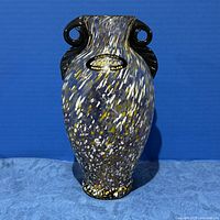 Full front view of speckled glass vase with label visible