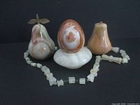 Group shot showing both pears, egg, holder and necklace