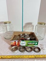 Lot overview showing two large Ball jars and box of metal lids and bands