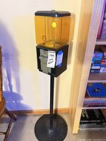 Full view of gumball machine on stand