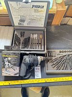 Drill, ProKit bit case open showing bits, General grinding attachment box, additional bit tray