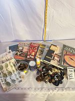 Entire lot showing books, buttons, stickers, paint can, glue bottle