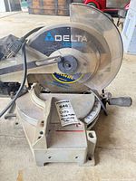 Left front view of Delta ShopMaster MS250 miter saw with installed blade and cord visible