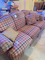 Full view of Flexsteel plaid sofa with cushions and pillows
