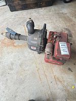 Overall view of Homelite pump with attached Briggs & Stratton engine, showing fittings and general wear