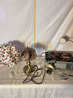 Overview of all items: brass lamp, puzzle lamp shade, desk lamp, car string lights, cords
