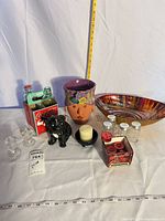 Group shot of entire lot displaying bowl, planter, dog figurine, shakers, Coke bottles in carrier, candlesticks, candles