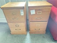 Front view of two oak 2-drawer filing cabinets side by side