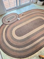 Both oval rugs laid out