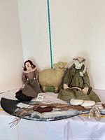 Full group shot of both rag dolls, sheep figurine and wooden goose wall hanging