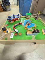 overall view of train table with buildings, engine, cars and track