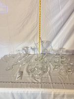 Full set of coupes, cordials, pitcher and stirrer laid out with measuring tape