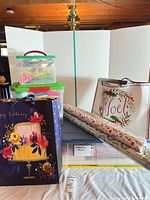 Overview of wrapping paper rolls, storage boxes, large birthday gift bag and Noel bag