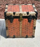 Front view showing brass lock, twin latches, riveted panels