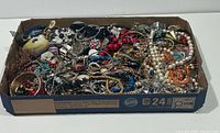 Full view of box with mixed jewellery pieces