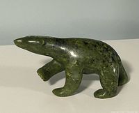 Full view of green serpentine walking polar bear sculpture