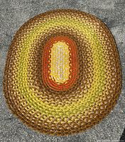 Full overhead view of entire oval rug showing all colour bands