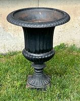 Front view of cast iron urn planter showing overall design and condition