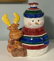 Front view of ceramic snowman cookie jar with moose