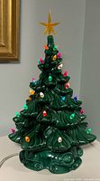 Front angle of ceramic Christmas tree showing bulbs and star