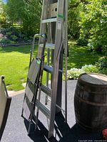 Ladder and folded step stool standing together