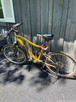 Left side view of entire yellow CCM full-suspension mountain bike