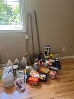 Full lot overview showing brooms and grouped cleaning supplies