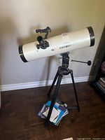 Entire telescope on tripod with books and accessories at base