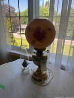 Electric lamp and oil lamp together on tabletop