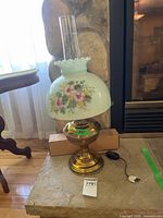 Full view of lamp showing shade, chimney, base and cord