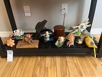 Full group of figurines and decorative pieces on shelf