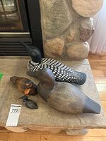 All four carved waterfowl figurines on stone hearth