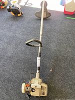 Full view of trimmer showing entire length, handle, shaft and guard
