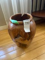 Front view of wooden vase showing knots and cracks