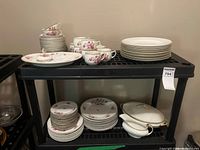 Full view of shelves with mixed Johnson Bros floral and Crown Royal gold trim china