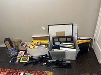 Full lot showing office supplies, electronics, greeting cards, CDs and storage tote
