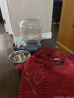 All items together: dispenser, stainless bowl, mat, harness