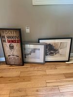 Front view of all three framed prints leaning against wall
