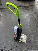 Full view of Bissell upright carpet cleaner showing handle, tank, nozzle