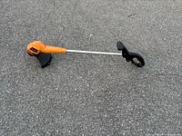 Full view of Black & Decker corded straight-shaft trimmer showing housing, shaft, guard