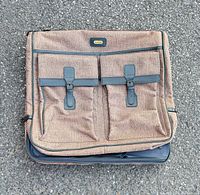 Front view showing woven fabric, two pockets, trim and brand badge