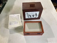 Wood photo box, tri-fold frame and sealed Carr frame grouped together