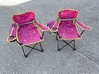 Front view of both pink child folding chairs on pavement