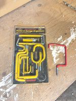 Sealed retail pack with yellow vinyl-coated hooks and separate red hook example