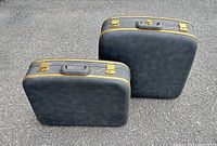 Two Fleetwing hard-shell suitcases closed showing exterior color, handles, latches