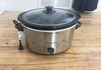 Front view of Hamilton Beach stainless steel slow cooker with lid on and power cord visible