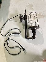 Full view of wall sconce, cord, inline switch, plug