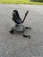 Overall view of Junior X Rider ride-on board showing seat, frame, wheels and clamp