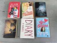 All six paperback novels front covers displayed on surface